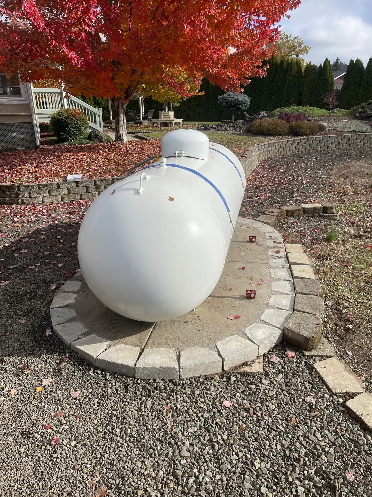 Propane tank with autumn maple backdrop