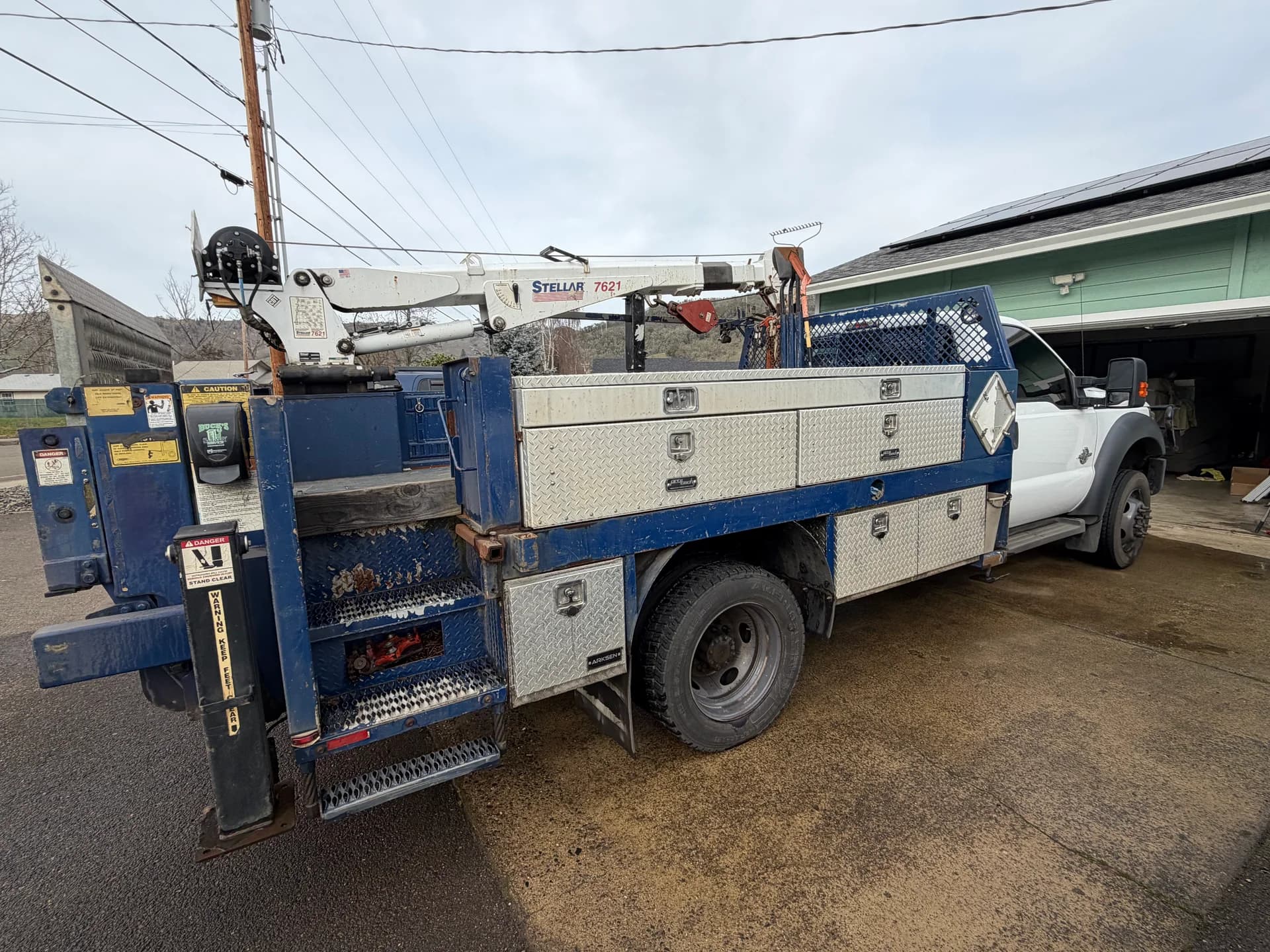 Rear of E. Davis service truck showing crane and equipment storage used for gas and generator installations.